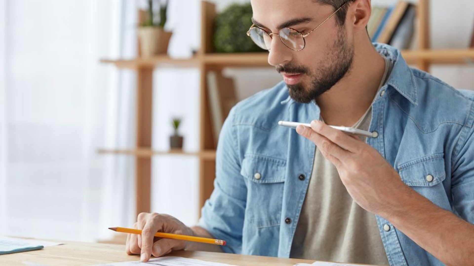 croppedshotofhandsomebusyyoungmaleofficeworkerstudies